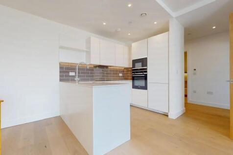 Bright and modern kitchen featuring sleek white...