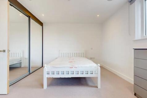 A bright and clean double bedroom featuring a w...