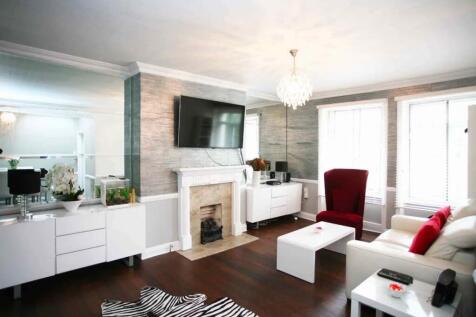 A stylish living room featuring a white leather...