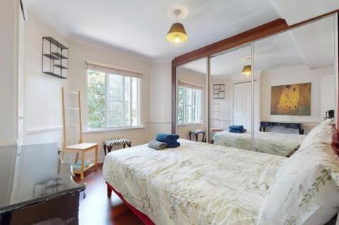 Bright and spacious master bedroom featuring a ...