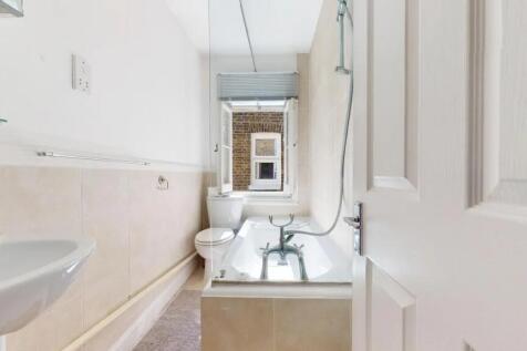 A bright and clean bathroom featuring a classic...