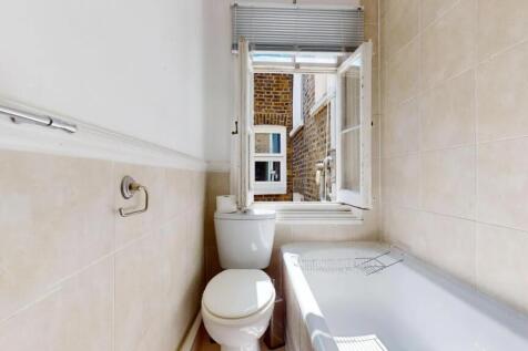 Bright bathroom suite featuring a clean white b...