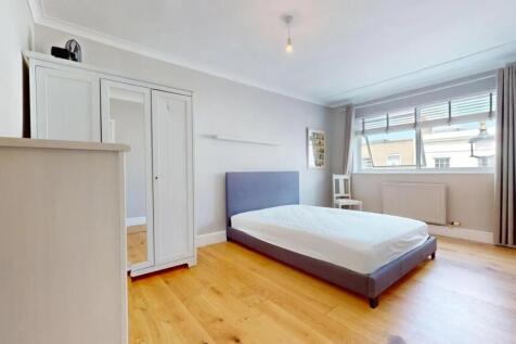 A bright and minimalist double bedroom featurin...