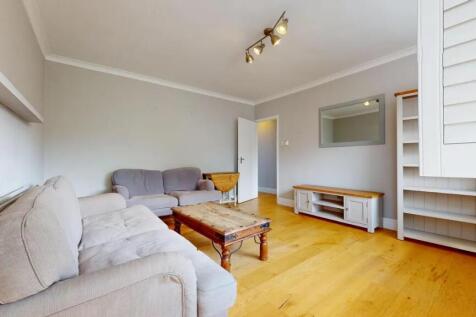 A cozy living room featuring comfortable sofas,...