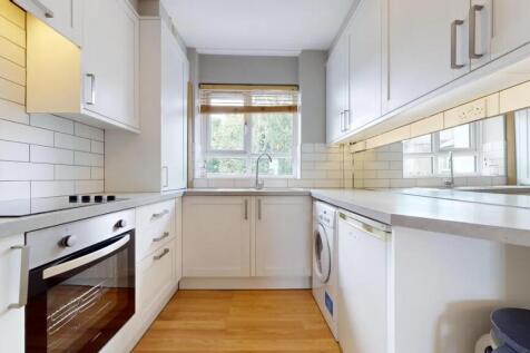 Bright and modern kitchen featuring white cabin...