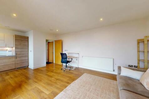 Bright and modern living room featuring warm wo...