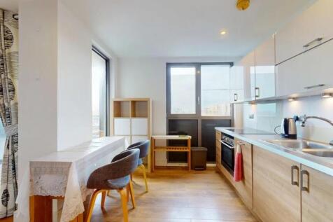 Bright and modern kitchen featuring sleek woode...