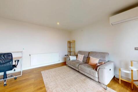 Bright and modern living room featuring a comfo...