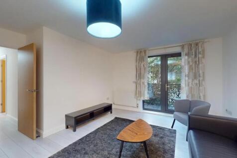A contemporary living room featuring a dark gre...