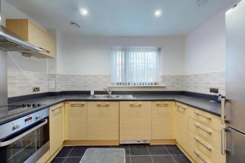 Bright and modern kitchen featuring ample count...