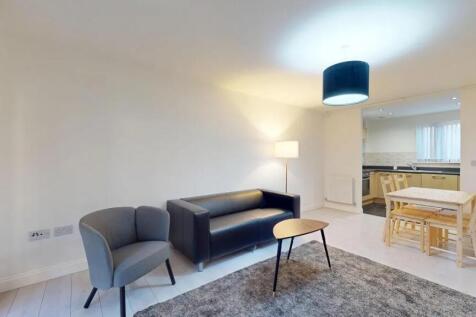 Bright and modern living room featuring a comfo...