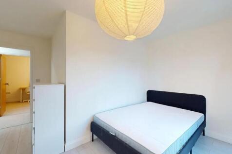A neat and bright double bedroom featuring a co...