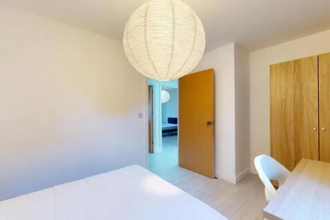 A bright and tidy double bedroom featuring a co...