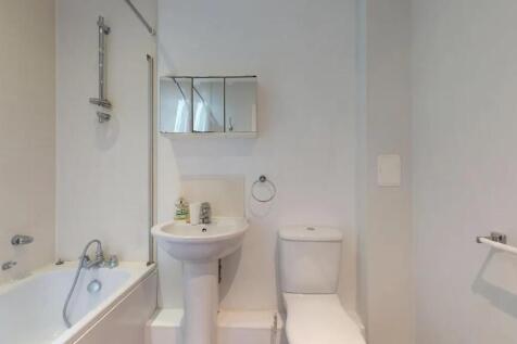 Bright and clean bathroom featuring a full-size...