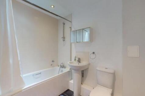 A clean and modern bathroom featuring a white b...