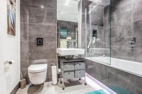 A sleek and modern bathroom suite featuring ele...