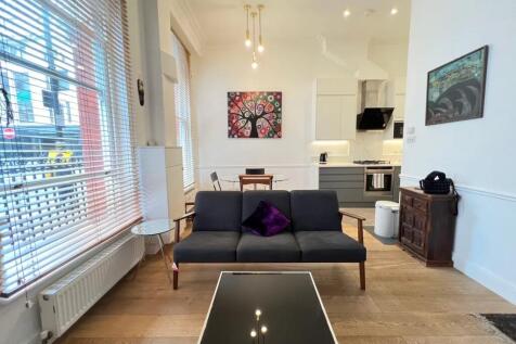 A stylish and modern living room featuring a sl...