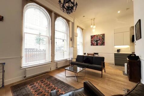 Bright and inviting living room featuring tall ...