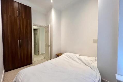 A cozy double bedroom featuring a large built-i...