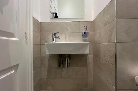 A modern and clean small single toilet area fea...