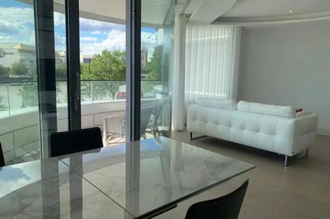 A modern living room featuring a sleek white so...