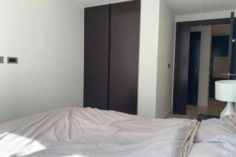 A clean and bright double bedroom featuring a l...