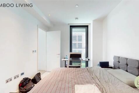 Bright and modern master bedroom featuring a co...