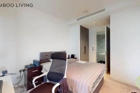 A modern master bedroom featuring a comfortable...