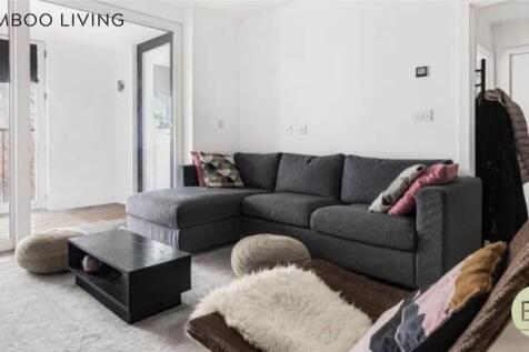 A bright and modern living room featuring a lar...