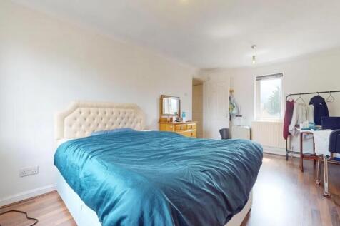 A spacious and bright master bedroom featuring ...