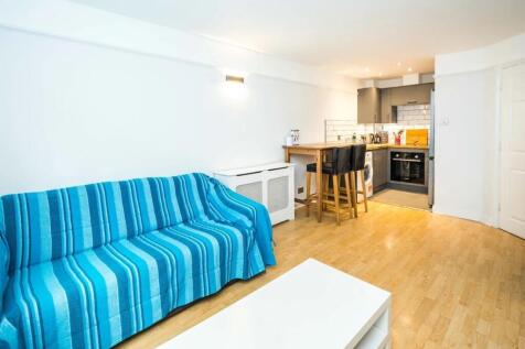 Bright and modern living room featuring a styli...