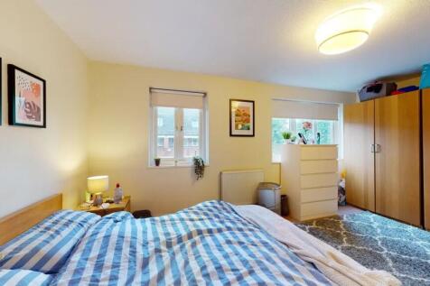 Bright master bedroom featuring a comfortable d...