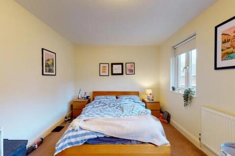 A cozy double bedroom featuring a neatly made b...
