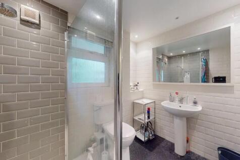 Bright and modern bathroom featuring a large mi...