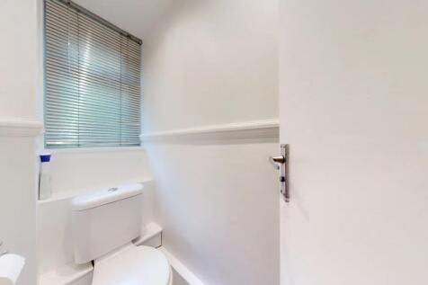 A neat and well-maintained single toilet room f...