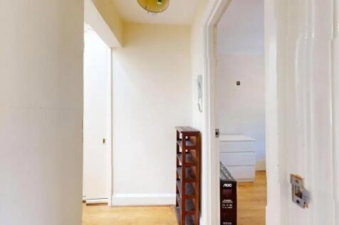 A bright and tidy hallway with light-colored wa...