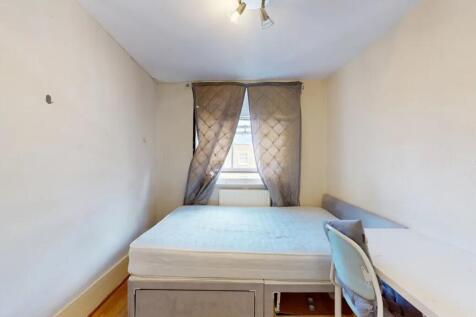 Cozy single bedroom featuring a comfortable bed...