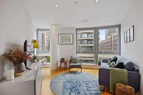 Bright and modern living room featuring large f...