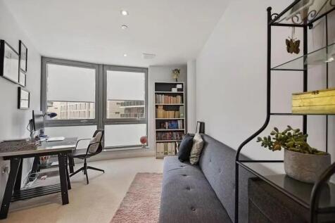 A modern living room featuring a comfortable gr...