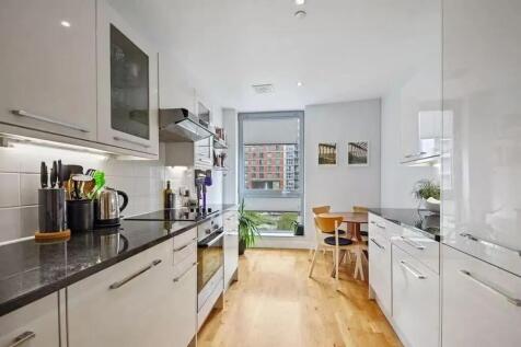 Bright and modern kitchen featuring sleek white...