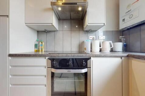 Bright and tidy kitchen featuring modern white ...