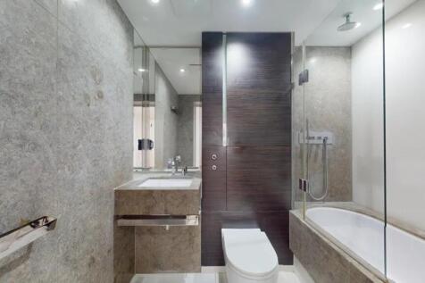 A modern and sleek bathroom suite featuring a c...