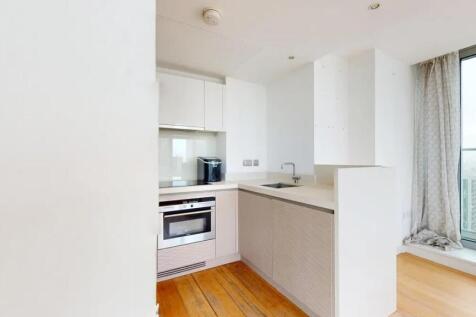 Bright and modern kitchen featuring sleek cabin...