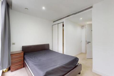 A clean and modern double bedroom featuring a c...