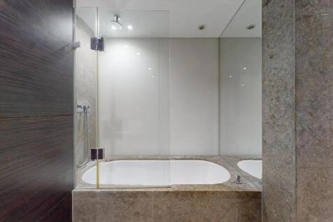 A sleek, modern bathroom suite featuring a buil...