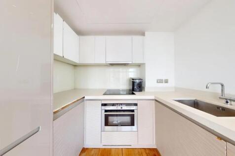 Bright and modern kitchen featuring sleek white...