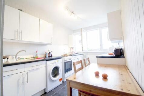 Bright and tidy kitchen featuring modern white ...