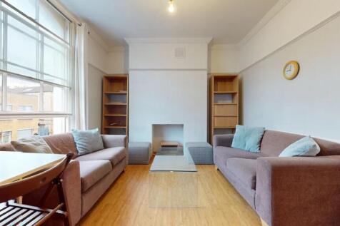 A bright and inviting living room featuring two...