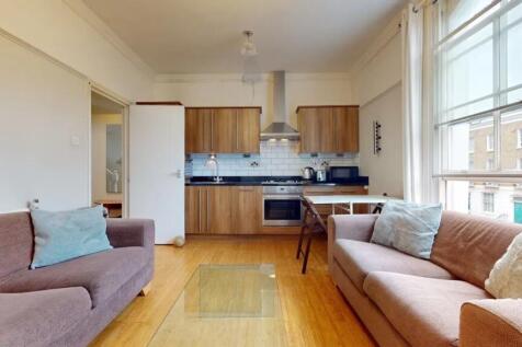 Bright and inviting living room with two comfor...