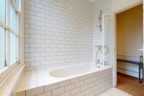 Bright and clean bathroom featuring a classic w...